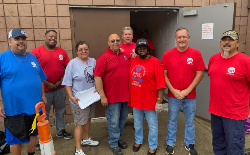 Group of people standing outside a building.
